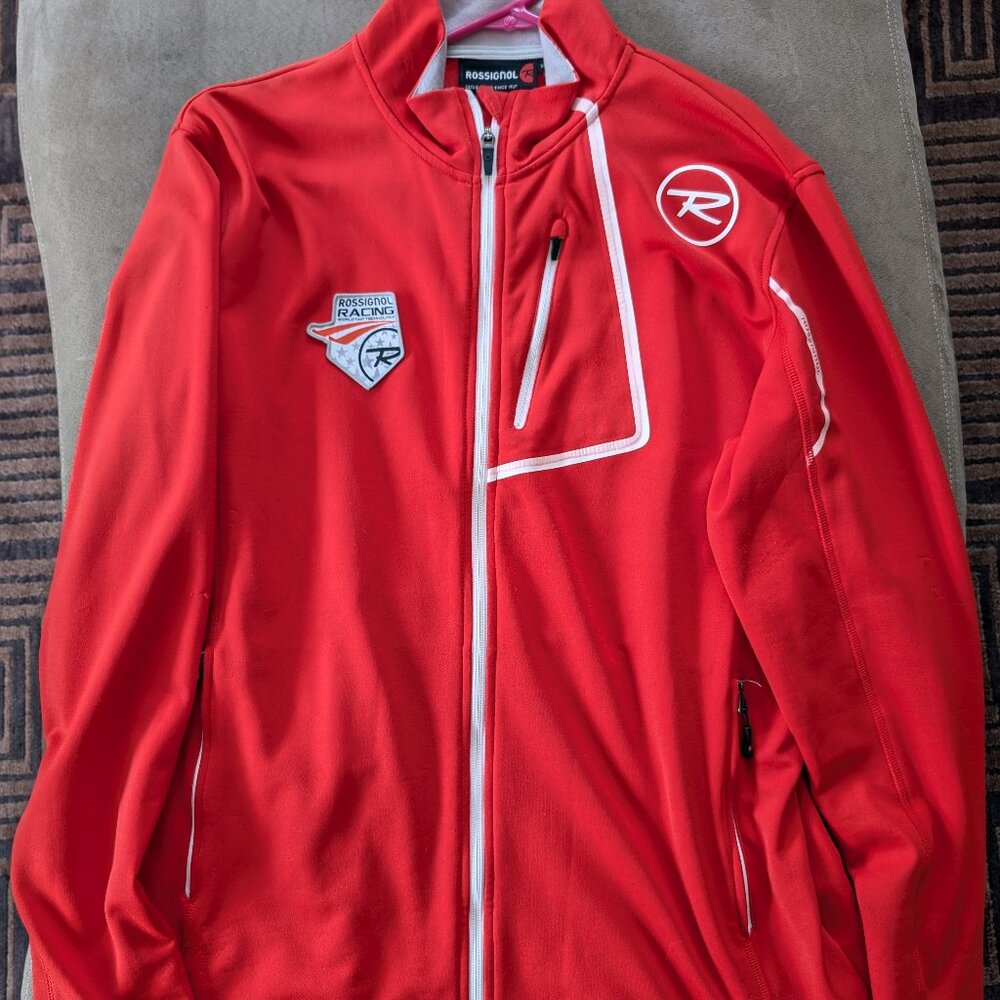 This is a pre-owned Rossignol Ski Racing World Cup men's jacket red in color.